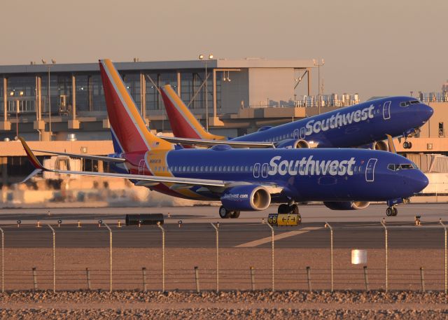 Boeing 737-800 (N8687A) - N8667D is taking off from 7L while N8687A is taxing on F. 