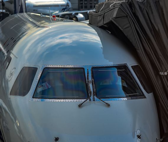 Embraer ERJ 175 (N633CZ) - A different point of view. Getting ready for their next flight the flight crew has a small discussion in the flightdeck