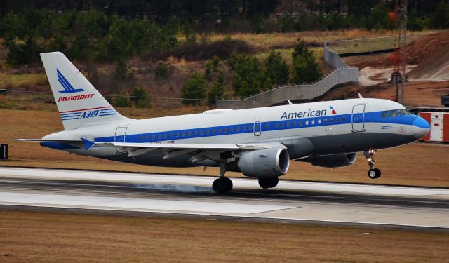 Airbus A319 (N744P) - JET PIEDMONT! The Piedmont retrojet kisses 5L after a five hour delayed flight from MIA (whew). Long live the Speedbird! Apropos for Piedmont's 71st anniversary.  From the RDU parking deck, 2/19/19.