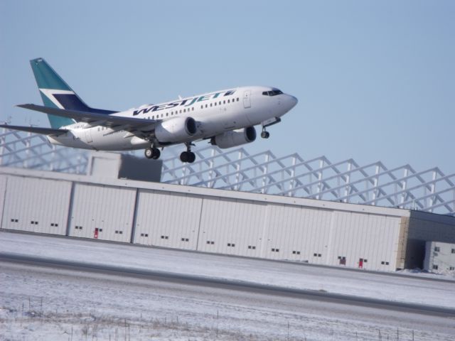 BOEING 737-600 (C-GWJU) - taking off of #07, taken by my 11 yr.old son.