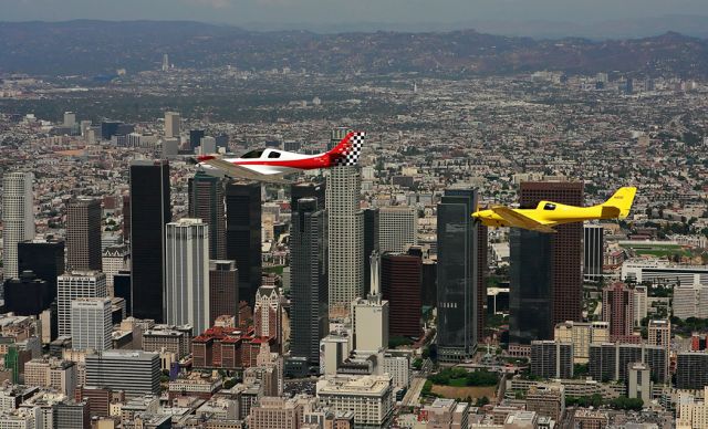 Experimental  (N73S) - A pair of Lancair 320/360s over downtown Los Angeles California. Front airplane is 2008 Oshkosh Grand Champion built by Craig Schulze. craig@skybolt.net  Rear airplane is David LaFaille.