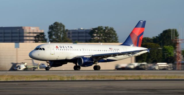 Airbus A319 (N322NB) - N322NB is the third departure of the morning, leaving just after seven for Minneapolis. Photo was taken on the east side of the field from the Signature parking lot.