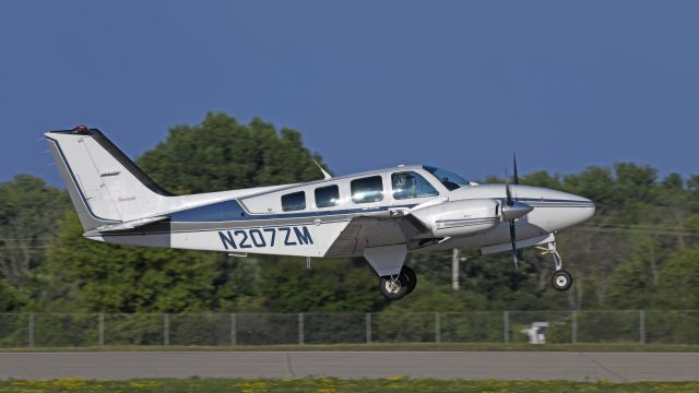 Beechcraft Baron (58) (N207ZM) - Departing AirVenture 2023 on runway 18R