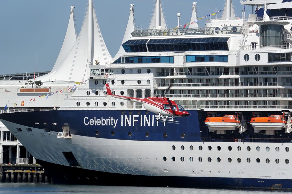 Bell JetRanger (C-GJSD) - Dwarfed by the 12 deck high Celebrity Infinity cruise ship.