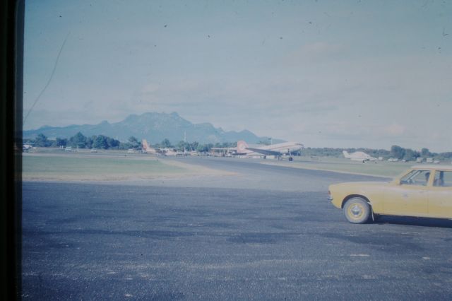 Douglas DC-3 (VH-MMF) - Air Tasmania DC3 parked in front of terminal, circa 1976