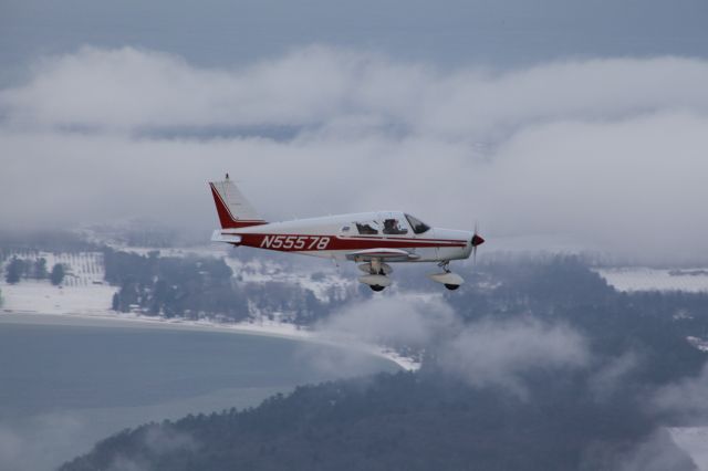 Piper Cherokee (N55578) - Taken with Old Mission Harbor and Old Mission, Michigan in the background.