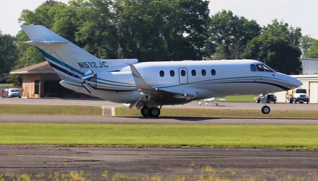 Hawker 800 (N512JC) - A Hawker 800XP deploying thrust reversers after arriving Runway 23, Thomas J. Brumlik Field, Albertville Regional Airport, AL - June 15, 2017. Auto color corrected due to haze and intense sunlight. Best seen full-size.