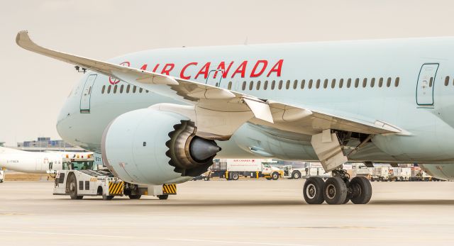 Boeing 787-9 Dreamliner (C-FNOE) - Being towed to the gate from the freight area...