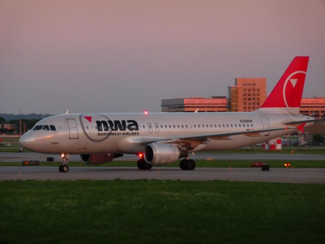 N358NW — - A NWA A320 taxis across the end of 12R at KMSP.  June 22, 2009.