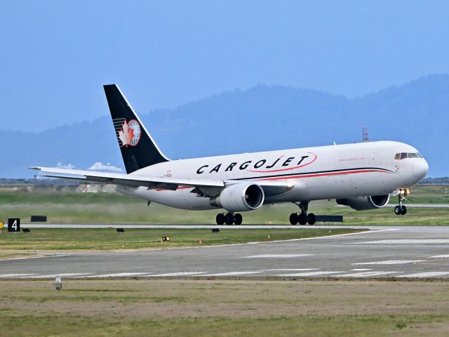 BOEING 767-300 (C-FDIJ) - early evening departure with a crusie ship in the background.