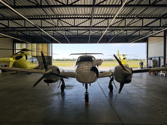 Diamond Twin Star (HB-LTV) - in a heli hangar in Lelystadt for the night.