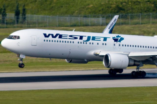 BOEING 767-300 (C-FOGT) - Touching down on 26R in from Gatwick.