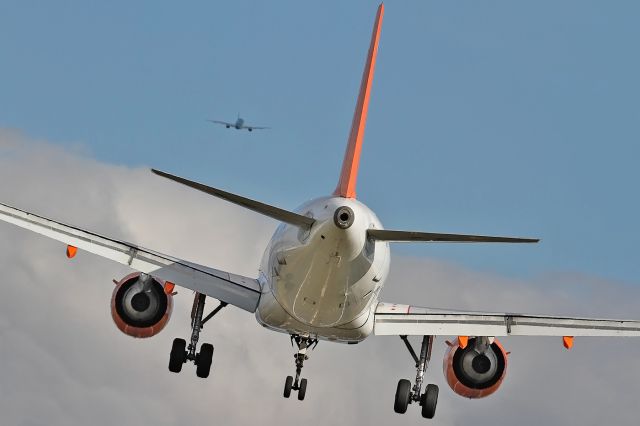 Airbus A319 (G-EZDL) - [cn.3567]. From the flight deck of our aircraft, EasyJet Airline Airbus A319-111 G-EZDL lining-up for Rwy 08R with Aer Lingus A319-111 on climbout at Gatwick EGKK Airport UK 17.2.2013.