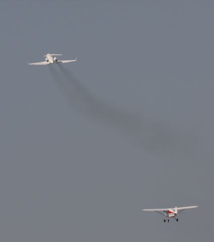 N4921JT — - Smaller propeller plane takes off on the left runway while the corporate aircraft is gaining speed and altittude from the right.