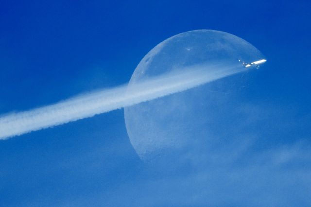 Boeing MD-11 (N285UP) - This picture is captured in Halifax, Canada at a slightly cloudy noon. The airplane flew right over the moon with a long "tail" at 33000 ft.