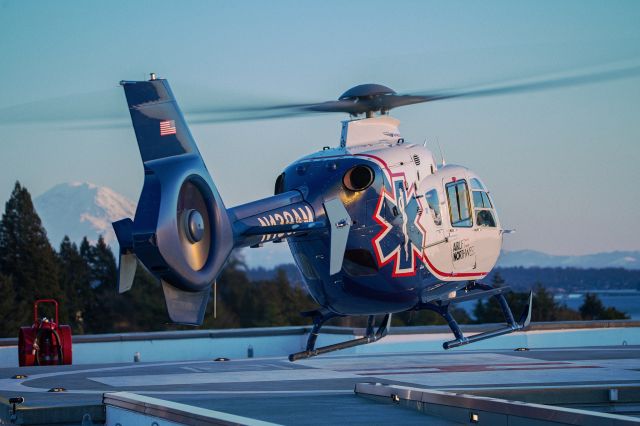 N139AM — - Airlift 7 landing on a rooftop helipad with Mount Rainer in the Distance.