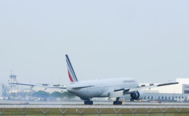 BOEING 777-300ER (F-GSQV) - Touching down and burning rubber "On a safe landing!"