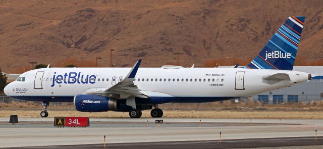 Airbus A320 (N806JB) - JBU's "Objects in Mirror Are Bluer Than They Appear" (N806JB), an A320, is lined up and waiting for tower clearance to go in this 2 PM click at RNO.  The tower was waiting for a QXE Dash 8 that had just landed to report clear of 34L.