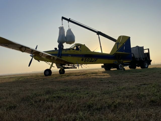 N502JF — - Loading the courageous pilots large balls in to the airplane takes great care br /br /Loading wet seed  rice  early morning  