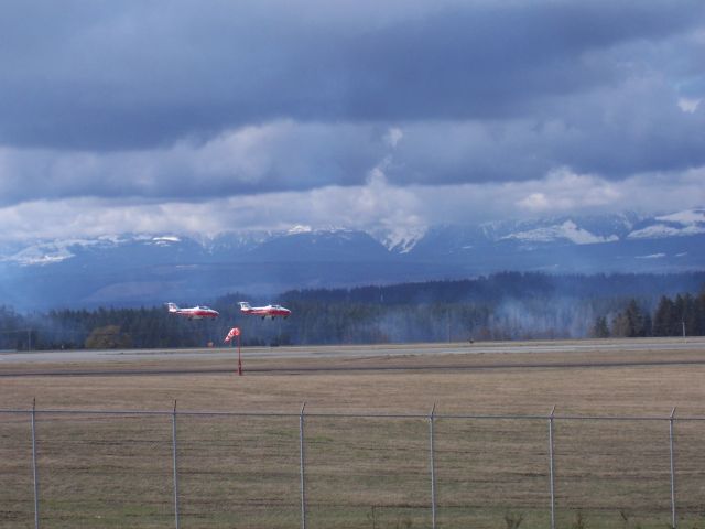 — — - Pair of Snowbirds land in our "snow-less Comox Valley"  not-so at higher elevations  of the Baufort Range  CFB Comox air-base