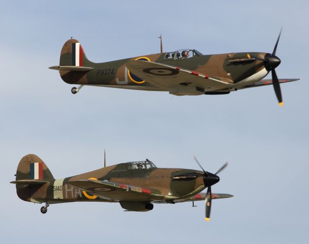 — — - A Spitfire and Hurricane from the Battle of Britain, perform a flypast.