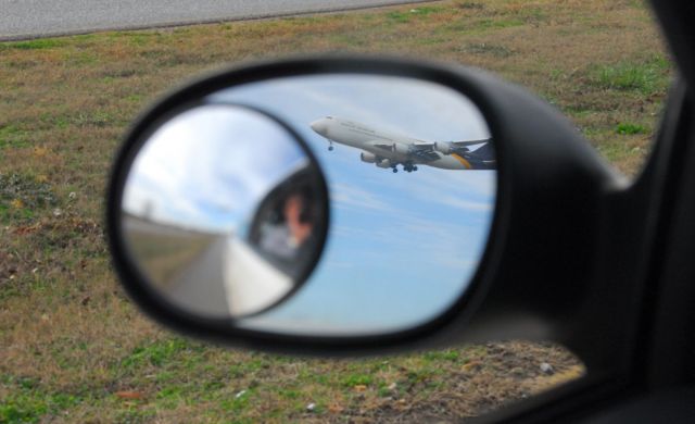 Boeing 747-200 — - UPS 747 passing behind a vehicle, catching image in side mirror.  Photo copyright: BlakeMathis.com