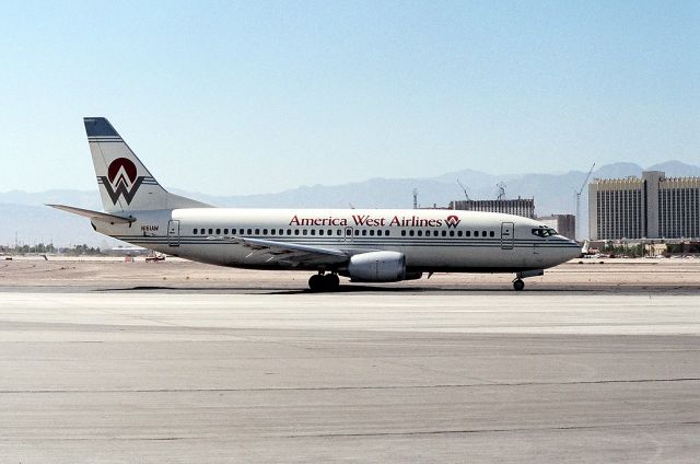 BOEING 737-300 (N161AW) - KLAS - Aug 1988 view of KLAS- looking west, the Tropicana Hotel is on the right, and the Excalibur is under construction behind this PHX bound airliner. It is hard to believe the changes in Vegas, let alone the airline industry after all of these years.