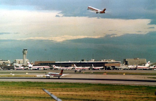 Beechcraft 19 Sport (N32017) - KDEN - Aug 1998 view of Stapleton - Note the MD-80 performing a wheels up go around, as the UAL Convair 580 ( right of the B-1900 middle runway ) The MD-80 was touching down and then immediately lifted as the UAL 580 had not cleared he runway yet - and I don't know why - poss missed a high speed. Anyways, everything just froze on the runways and taxi ways until ATC cleared everybody. I had 3 hours this AM to film and foto at Stapleton, and this was one busy airport - even Aug 1988 standards.