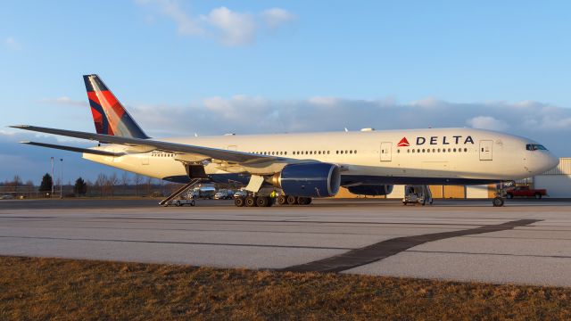 Boeing 777-200 (N860DA) - A Delta 777-200 sits in warm rays of the setting sun at Corporate Wings..12/23/2018