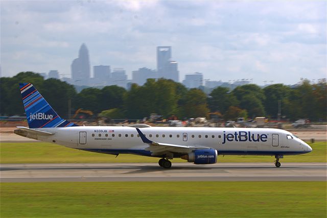 N339JB — - 339JB taking off on Rwy 18C with the City of Charlotte in the background