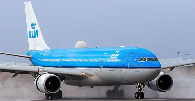 Airbus A330-200 (PH-AOF) - KLM Royal Dutch Airlines reg PH-AOF blow drying the active runaway before coming to a stop at TNCM St Maarten.br /05/10/2018