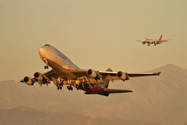 Boeing 747-400 (HL7417) - An incredibly lightly loaded Asiana Cargo 747-400BDSF rockets out of LAX, with a Turkish 777-300ER on final in the background. 