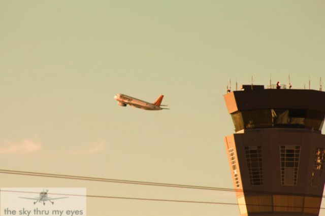 Airbus A320 (VH-VNO) - on operation road a tiger air a320 passing by the atc tower on its climb to syd