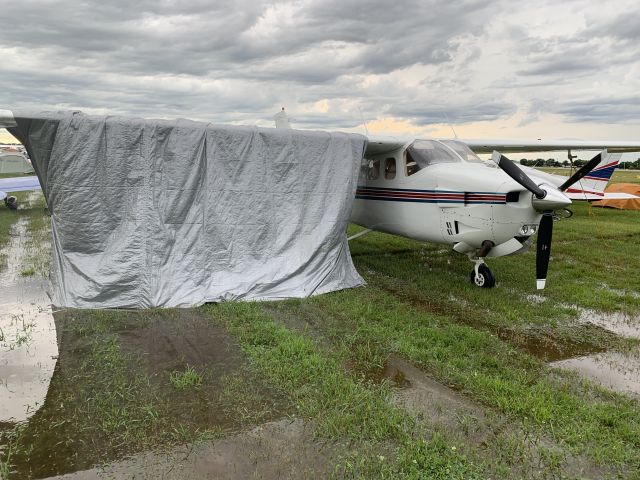 Cessna Centurion (N92CK) - The tarp over the wing saved us from blowing rain.  Highly recommended.