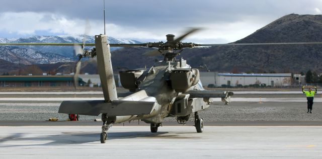 Boeing Longbow Apache (02-9027) - One of a flight of four AH-64 Apaches being marshalled to a parking position on the Atlantic Aviation ramp. One had arrived earlier in the day and three came in during this photo sequence.