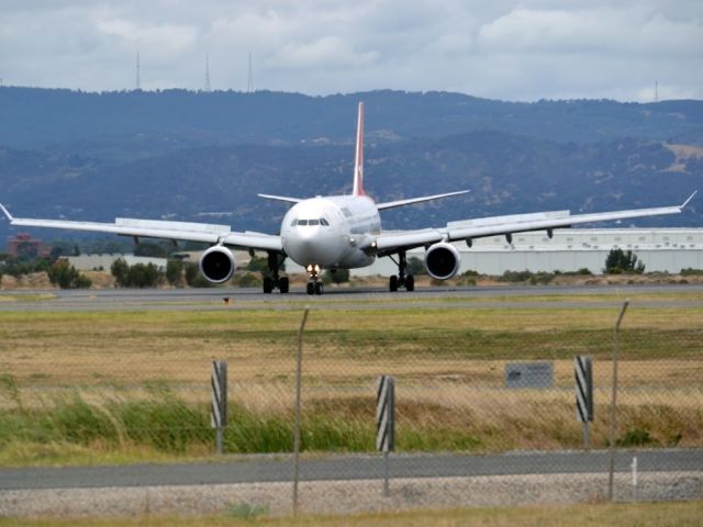 Airbus A330-300 (VH-QPD) - Turning from runway 23 on to taxi-way, on arrival from Sydney en-route to Singapore. Tuesday 27th December 2011.