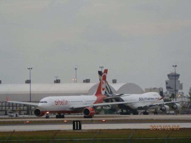 Airbus A330-200 (D-ALPF) - Air Berlin,Waves goodbye,To,a parked Southern Air 742F