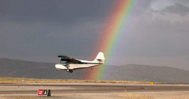 Grumman Goose (N39FG) - Summer Wind, a privately owned Grumman Goose (N39FG), passes the first of two rainbows as it is landing on Reno Stead Airports Runway 32 in the early evening hours.  Summer Wind was one of three aircraft that landed at RTS while the rainbows were visible.  