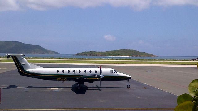 Beechcraft 1900 (VP-LVI) - Right hand side on top of the sea side grape tree