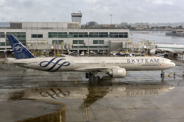 BOEING 777-300ER (F-GZNE) - 1st February, 2024: Flight AF83 bound for Paris Charles de Gaulle completing push back while reflecting on the rain drenched concrete ramp at SFO. 