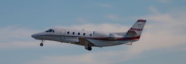 Cessna Citation Excel/XLS (N664AF) - Taking off to the east the aircraft passed in front of me allowing this picture angle.  Wheels going up.