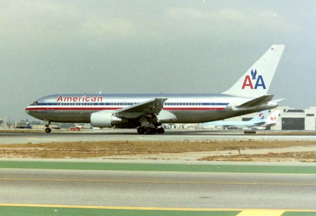 BOEING 767-200 (N301AA) - KLAX Boeing 767-2 N301AA Americans 1st 767-2 rolling out on Runway 25L at Los Angeles. I took this photo from the old Imperial Terminal parking lot in March 1990 when one could park here all day and film airliners if one wanted too. CN 22307 LN: 8 The cockpit shows preserved at an Aviation Museum in Las Vegas, NV USA, delivered new November 1982 to American.