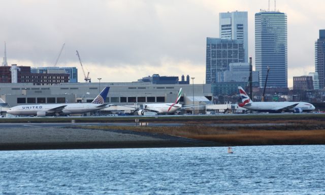 Boeing 777-200 (N224UA) - Triple 7 trifecta United and British Airways B777-200s push back simultaneosly with Emirates B777-300 in between.