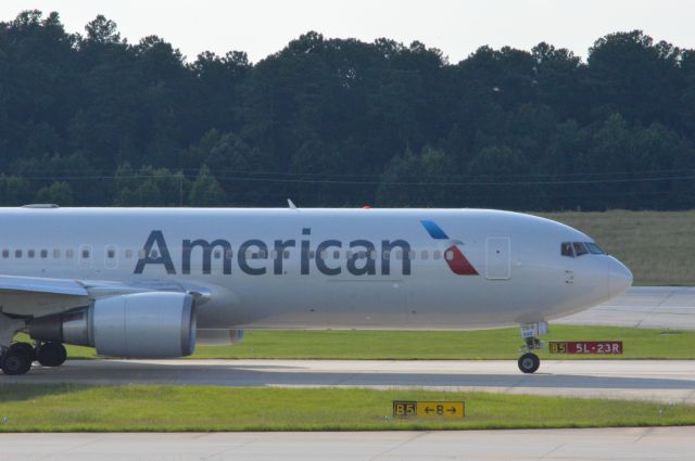 BOEING 767-300 (N392AN) - American 174 taxing to runway 23R for departure out to London Heathrow at 6;10 PM EDT.  Taken June 30, 2016 with Nikon D3200 mounting 55-200mm lens.   