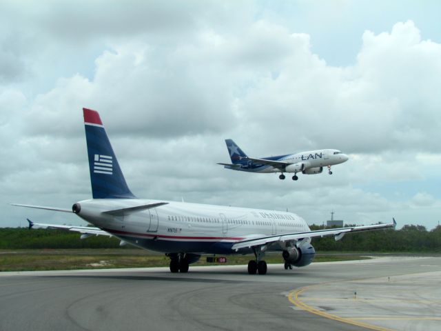 Airbus A321 (N167US) - On holding point of runway 08 while Lan Peru 2594 is on very short final.