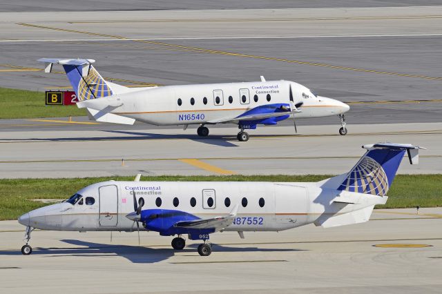 Beechcraft 1900 (N87552) - N16540 on taxi by N87552, another 2fer at KFLL