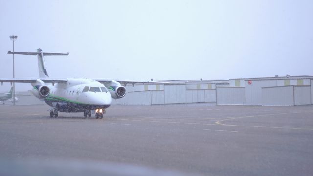 Fairchild Dornier 328JET (N394DC) - Taxiing for take off on an early winter morning through the lingering flurries.