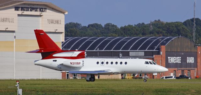 Dassault Falcon 50 (N311BP) - Brad Paisleys Falcon 50 taxiing out to runway 02C for a departure to Chicago.  According to his Twitter account, Mr. Paisley had an engagement in Chicago on the evening this photograph was taken.