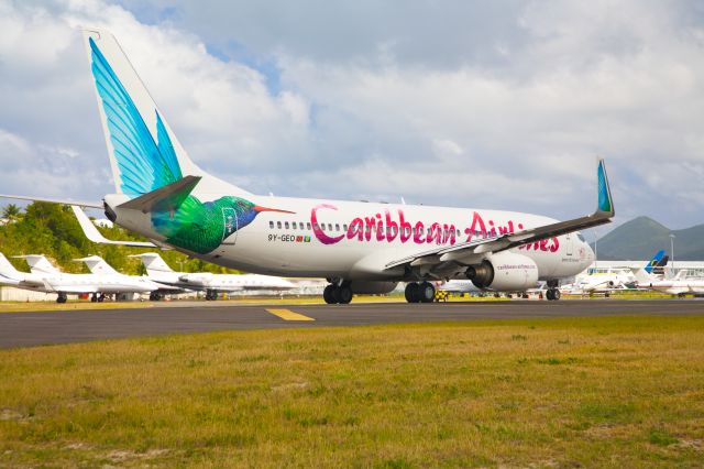 Boeing 737-800 (9Y-GEO) - Lined up for departure on Rwy 10 in Sint Maarten, colourfully painted 737-800 on Jan 5, 2013