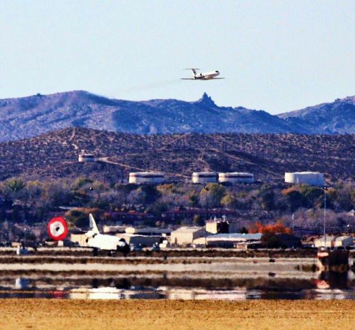 ELL105 — - This is the shuttle Endeavour landing at Edwards AFB. I was very far away when this photo was taken with my 100-400 mm lens. At least I captured the shoot coming out and the spotter plane.